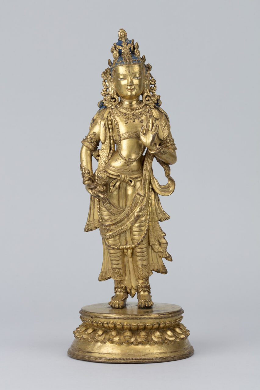 Golden statue depicting standing Bodhisattva wearing pleated dhoti and finely-modeled crown, earrings, armbands, and necklaces