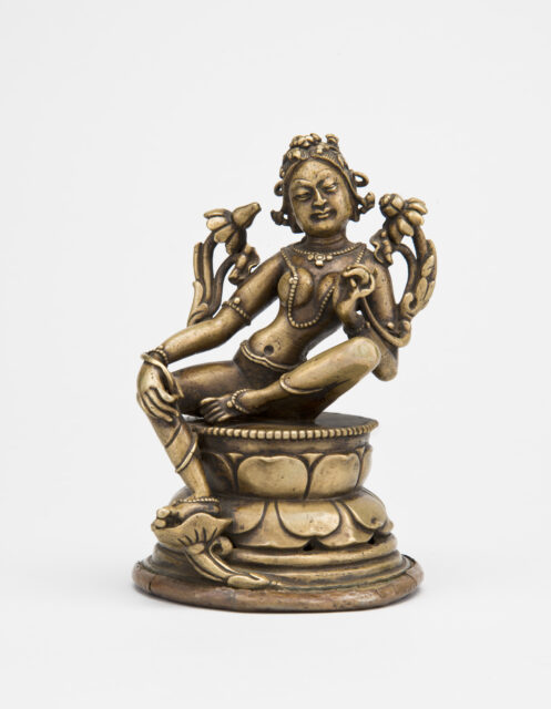 Bronze-colored sculpture depicting Bodhisattva seated on lotus pedestal, torso inclined to the right, holding blossoms