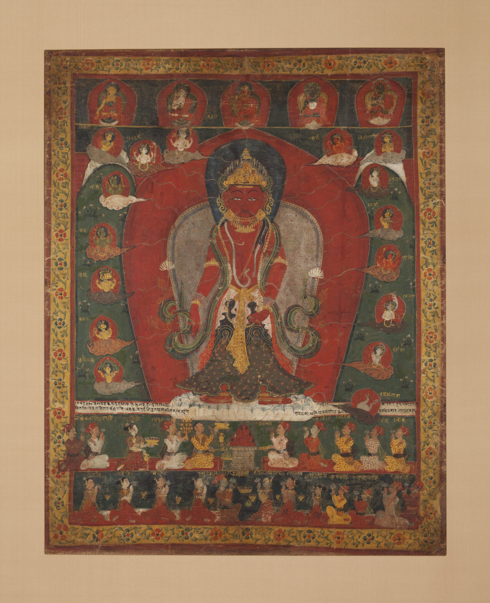 Painting depicting Bodhisattva wearing flared dhoti and golden belt standing amongst small deity portraits, above rows of attendants