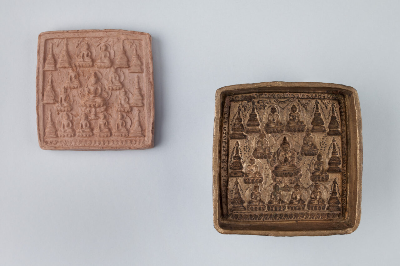 Two halves of clay and copper mold used to produce votive tablet depicting Buddhas and stupa forms