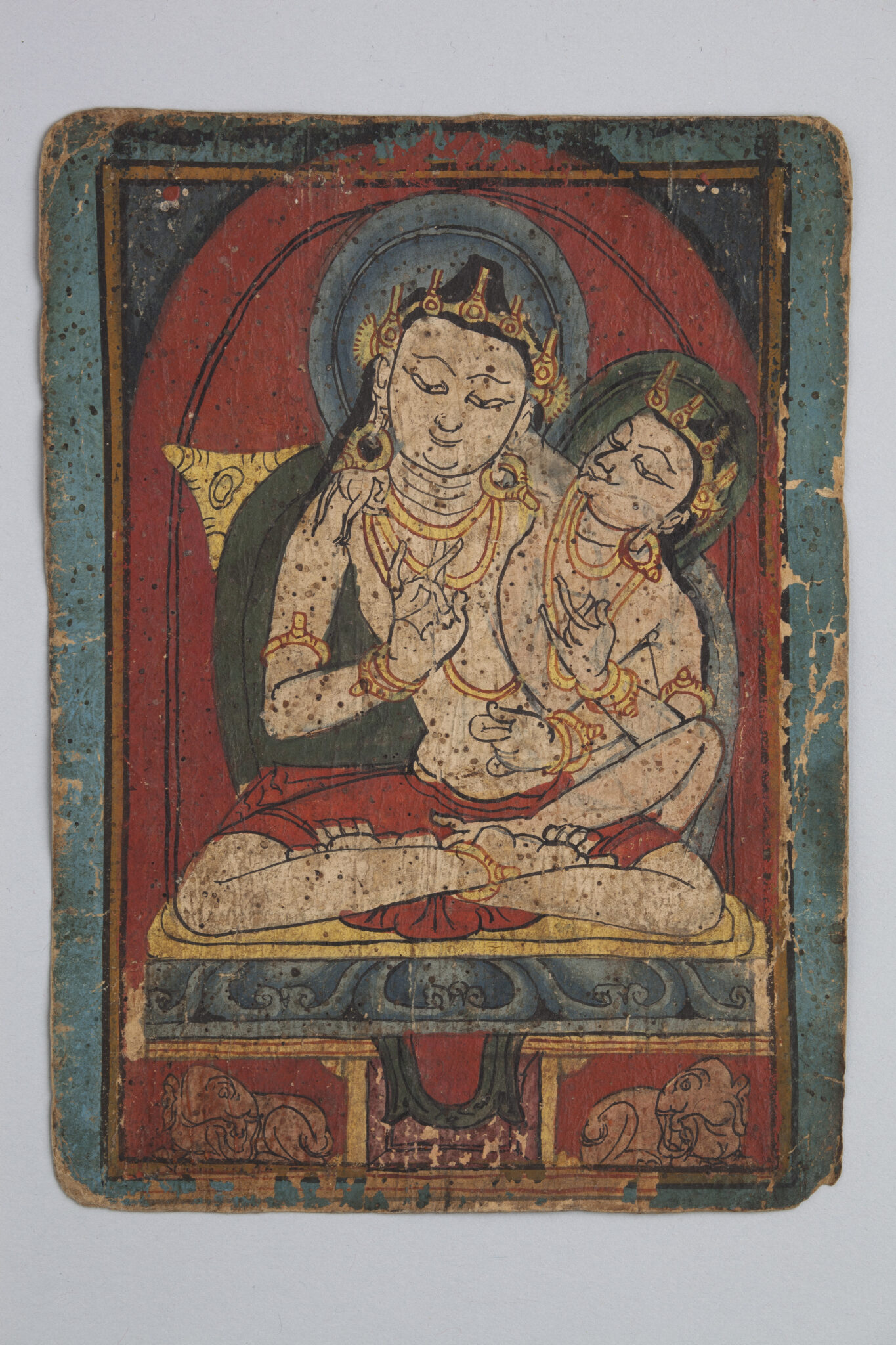 Buddha wearing crown and golden necklaces, left hand held in mudra at chest, consort appearing from behind right shoulder
