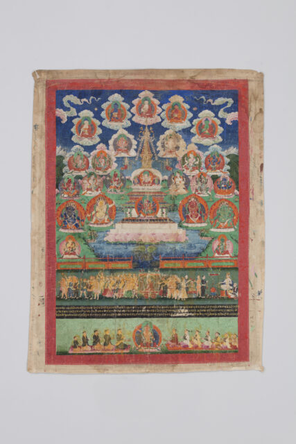Stupa and multitude of deity portraits hover above landscape at top two-thirds; two scenes featuring throngs of figures at bottom third
