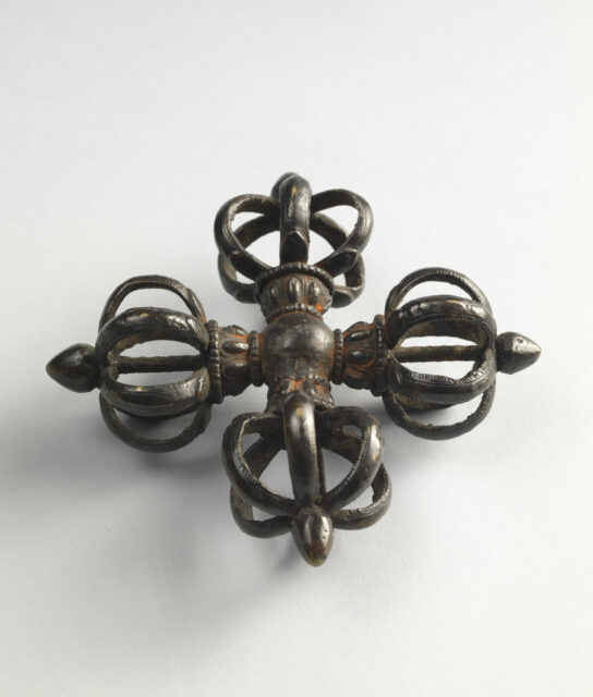 Religious implement in shape of crossed vajras: four open spheres formed by curved prongs connected by central closed sphere