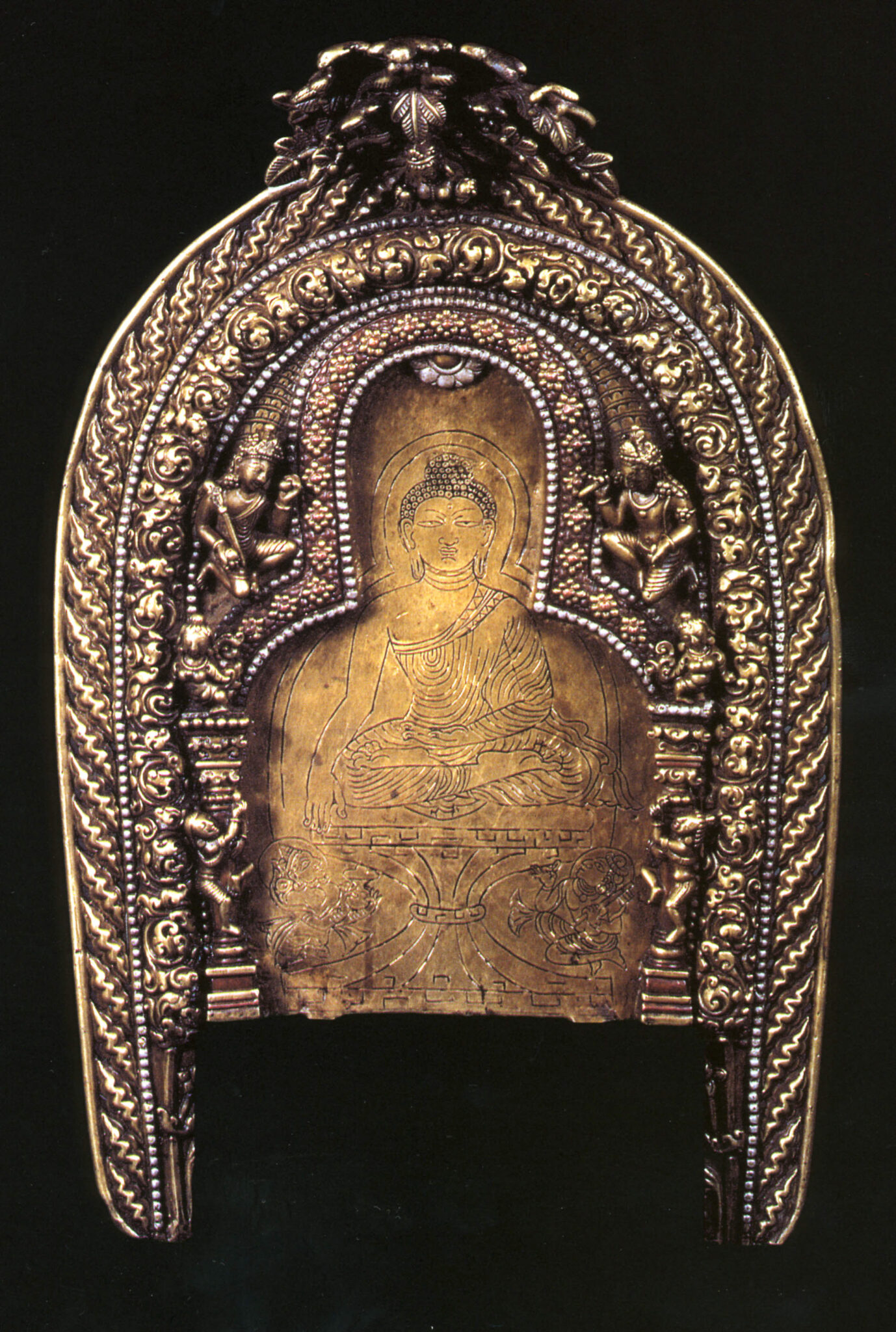 Brasswork featuring etched image of seated Buddha enclosed by arched structure and two patterned, horseshoe-shaped bands