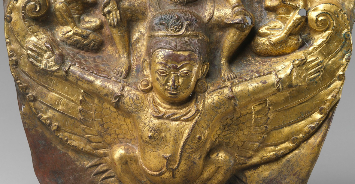 Close view of Garuda attired in jewelry and diadem, crouching on splayed knees with outstretched arms and wings