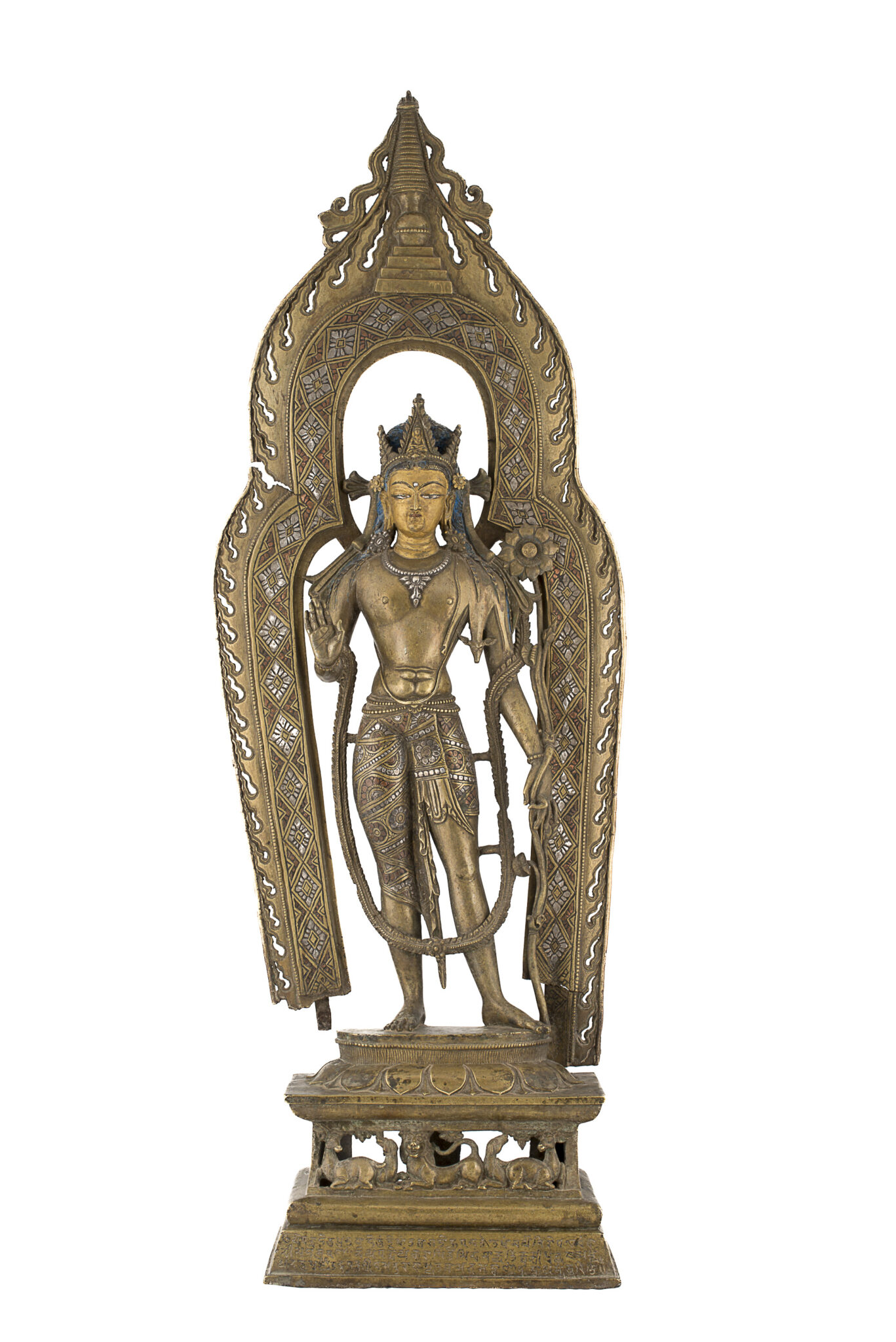 Yellow brass statue of Bodhisattva holding blossom and standing before patterned, open nimbus topped with stupa