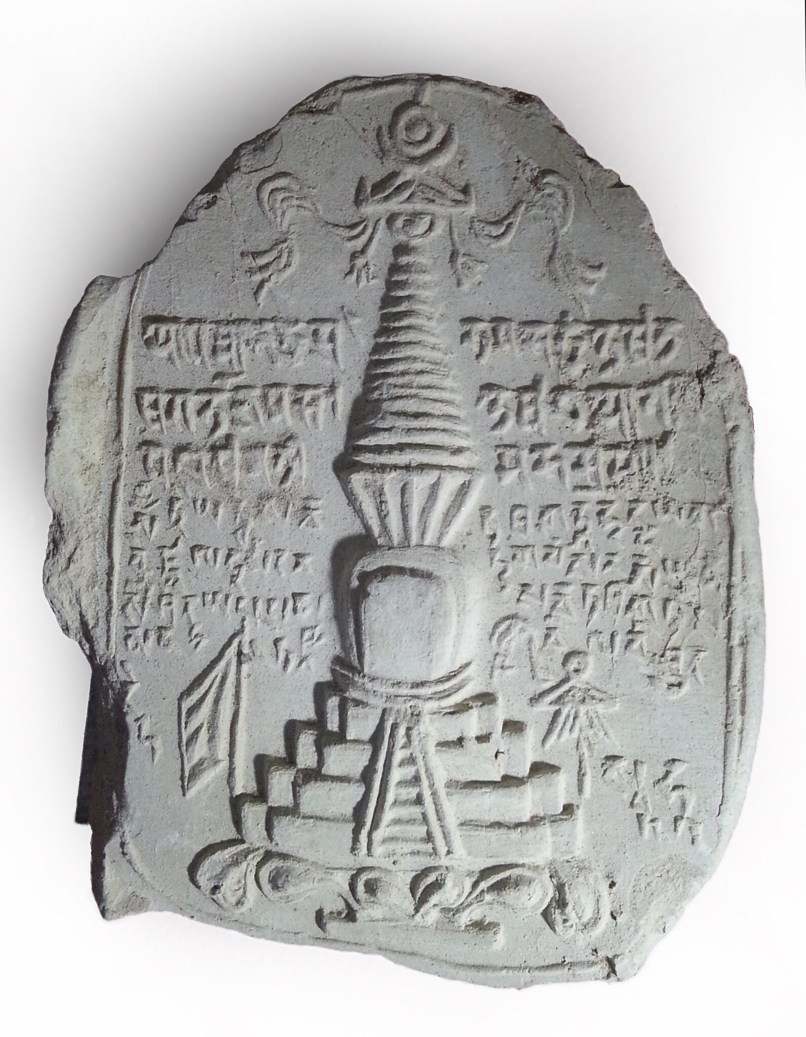 Well-defined stupa featuring tiered base and conical tower surrounded by lines of Tibetan text