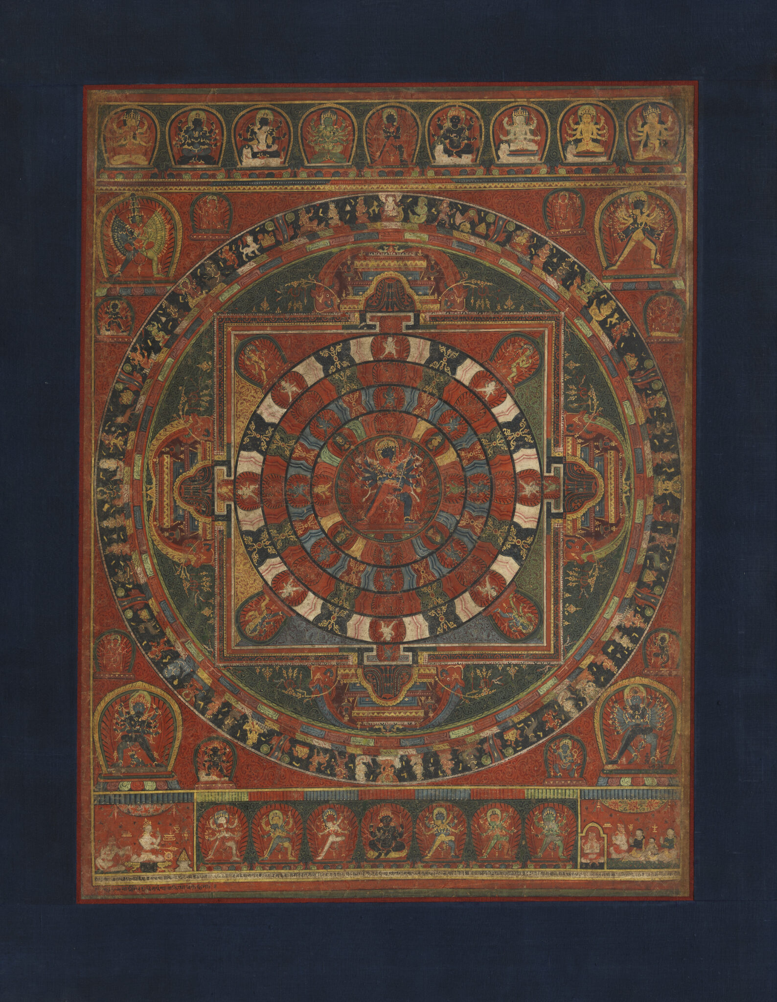 Sacred painting composed of geometric forms adorned with symbolic motifs; deep-red with accents in green, blue, yellow, and white
