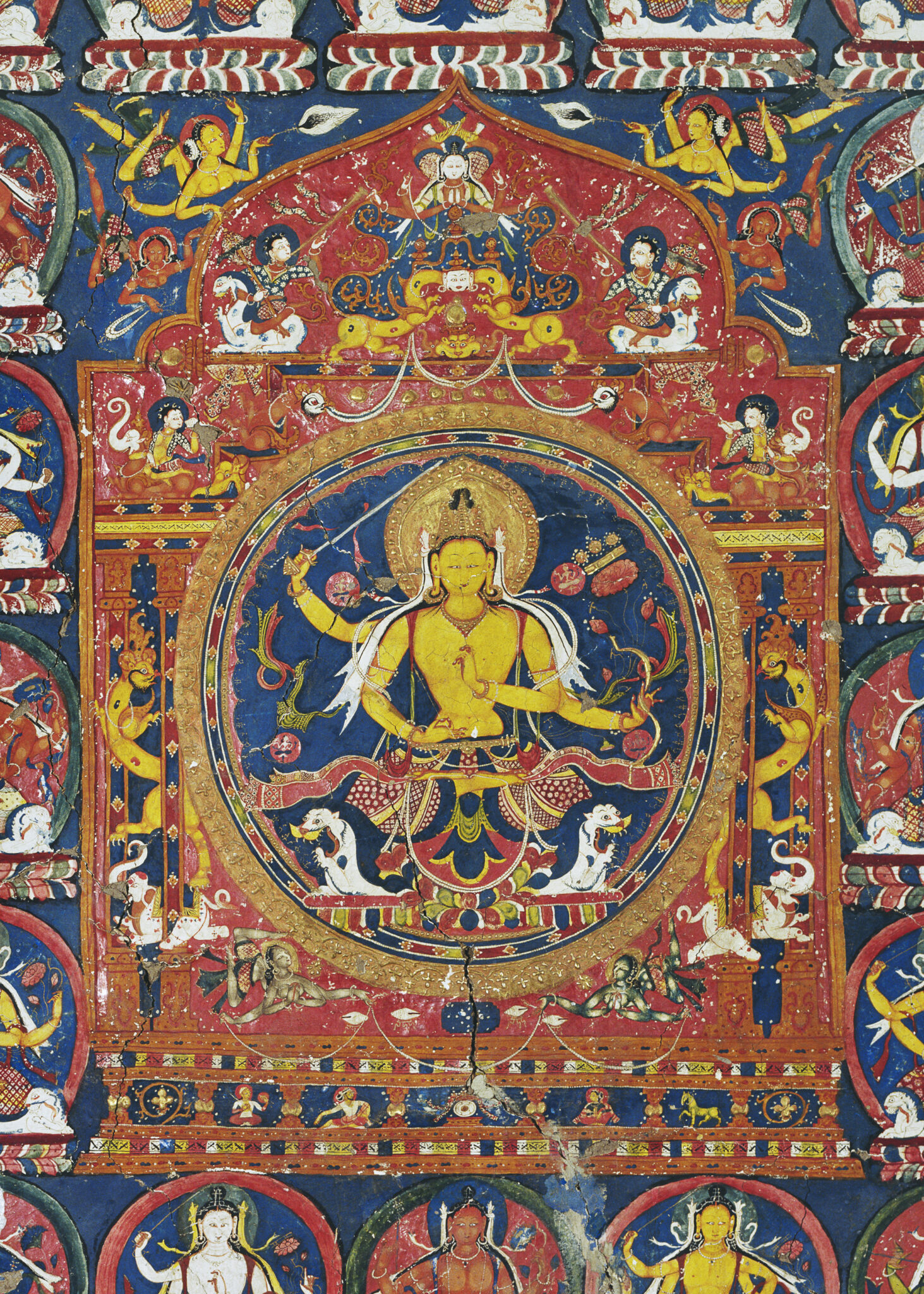 Yellow-skinned deity seated at center of mandala decorated with deity portraits, animals, and apsaras (flying divinities)