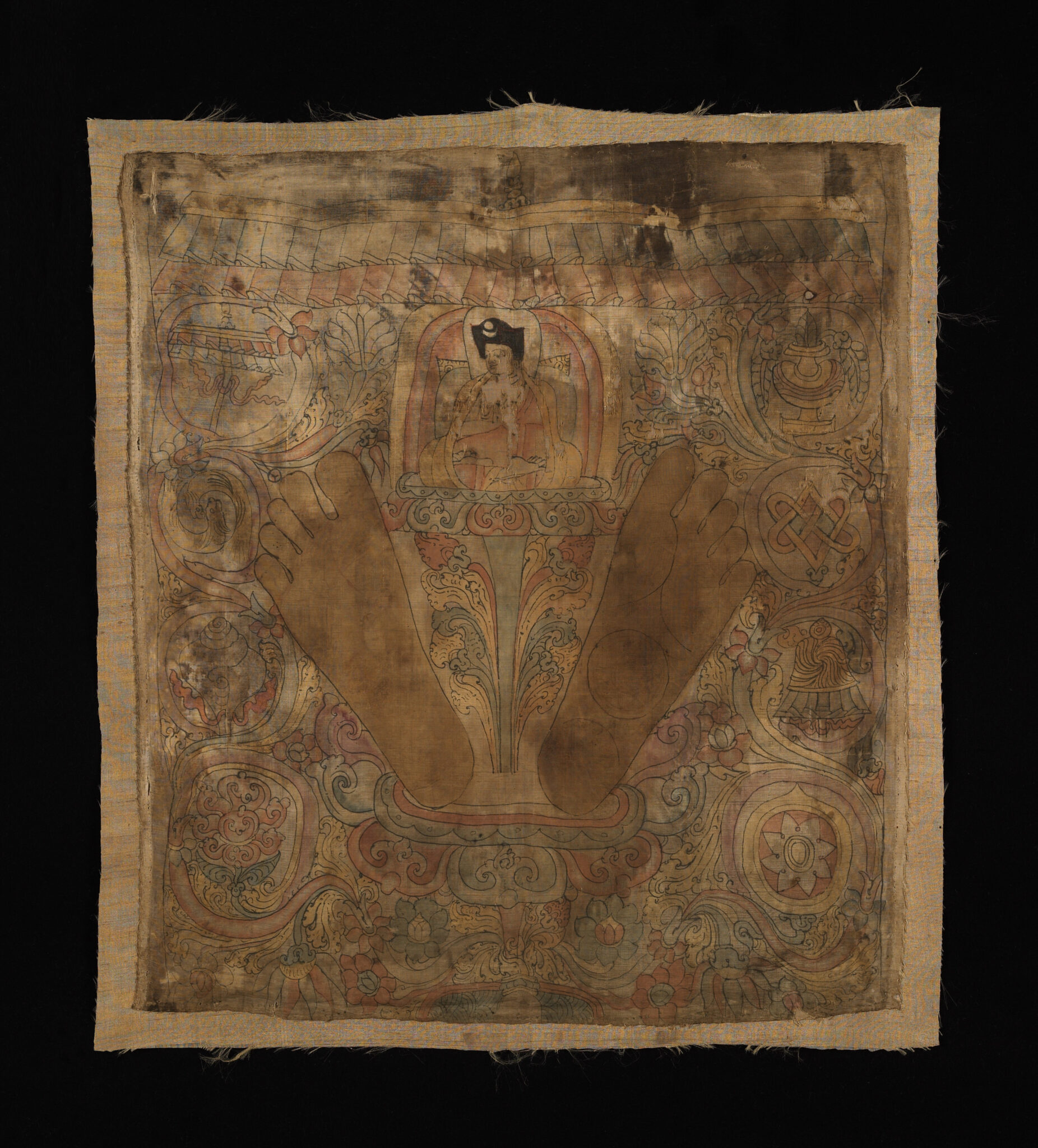 Mottled sepia textile featuring angled footprints standing astride deity seated on lotus amid floral motifs
