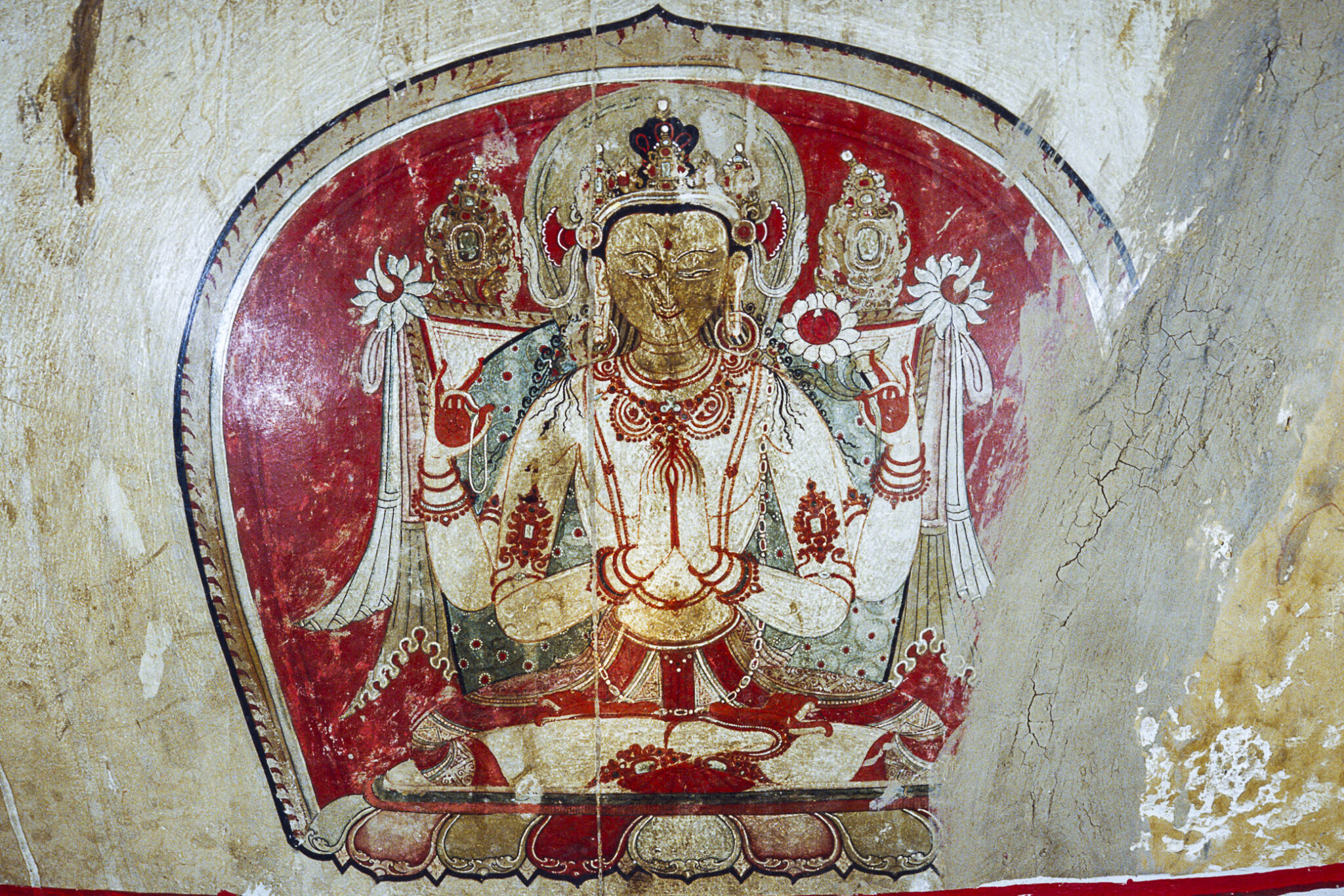 Four-armed Bodhisattva seated on lotus blossom within red pointed nimbus; painted on side of chorten