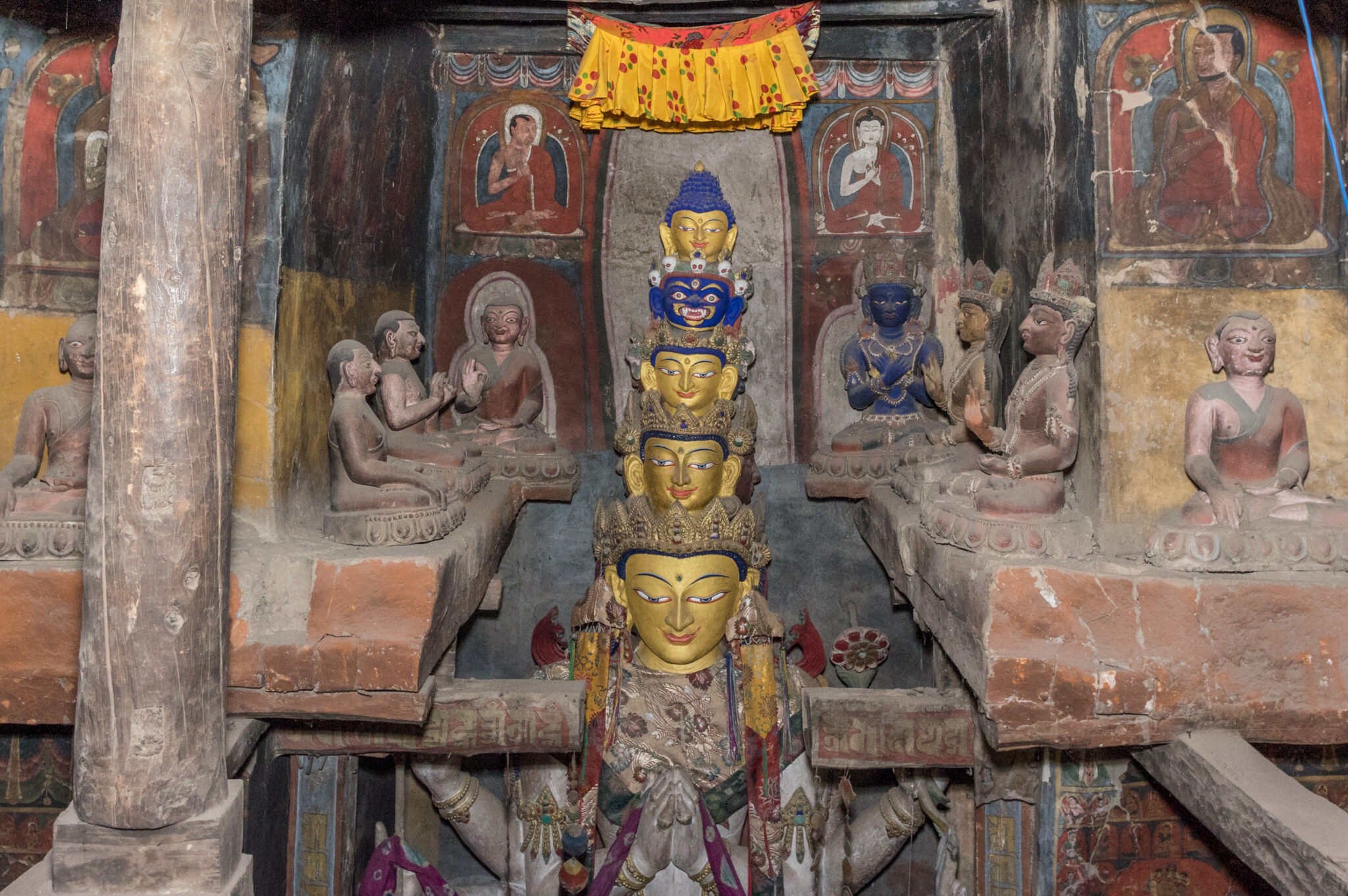 View of niche ledge decorated with murals and statues; at level with faces of eleven-headed Bodhisattva statue