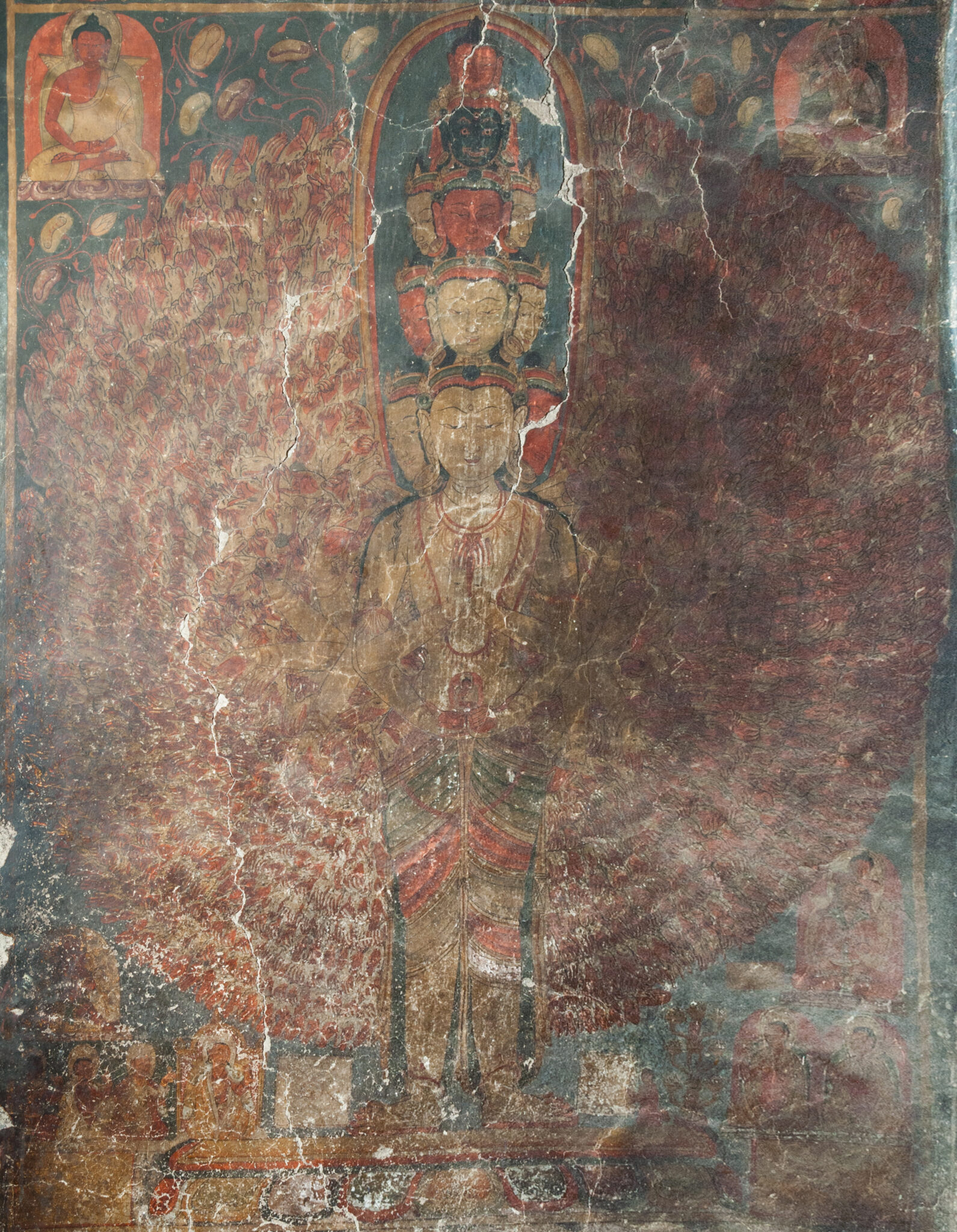 Mural depicting Bodhisattva with eleven heads arranged in five tiers; arms so numerous they resemble wings