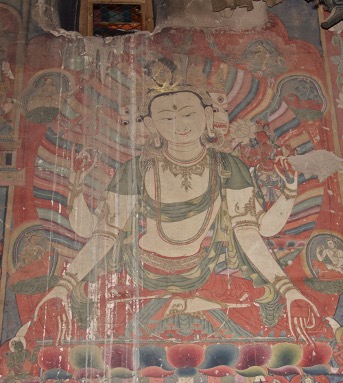 Three-faced, four-armed Bodhisattva wearing red dhoti and delicate green sash sits before rainbow nimbus