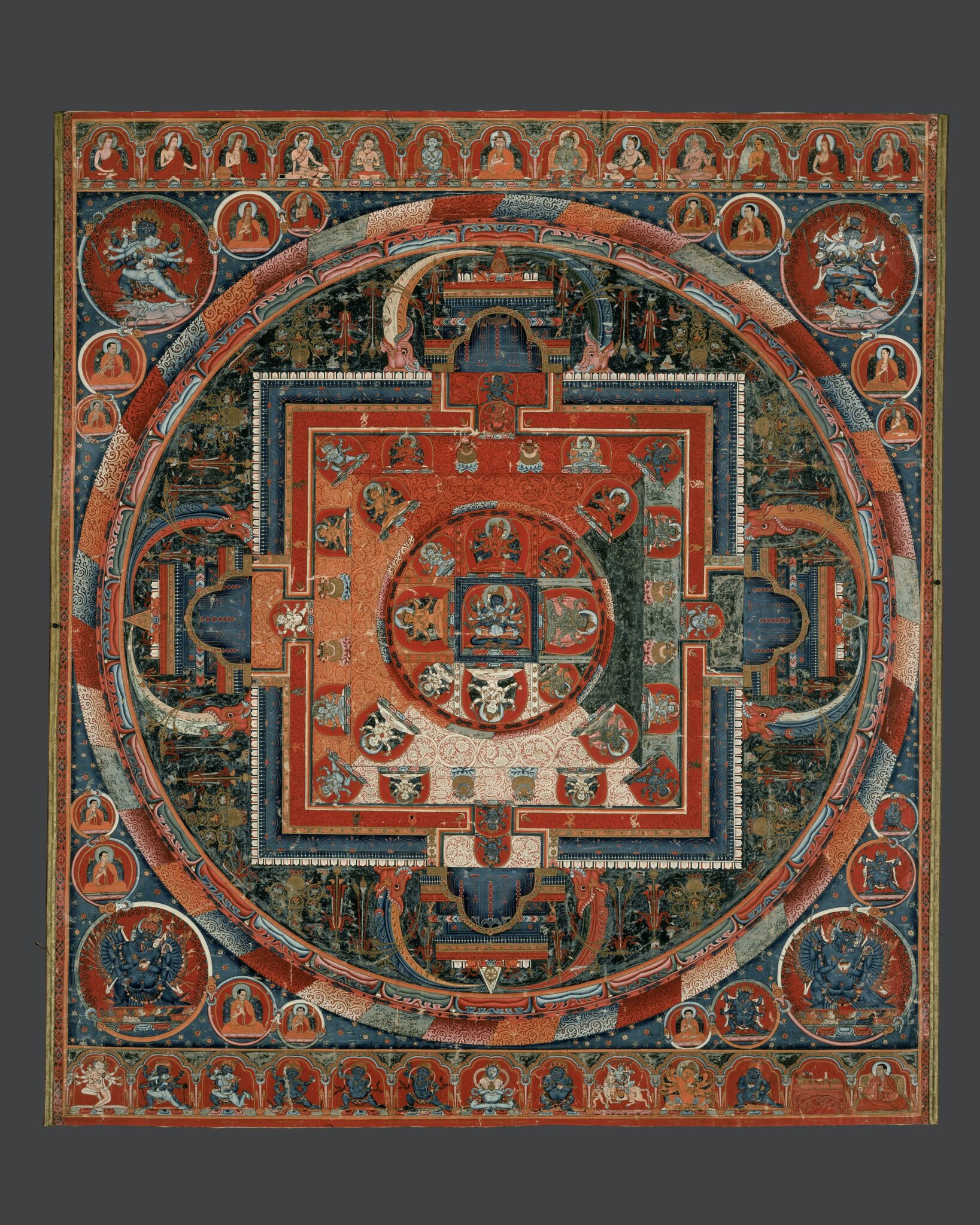 Mandala in jewel tones featuring richly ornamented green field between inner square and outer circles
