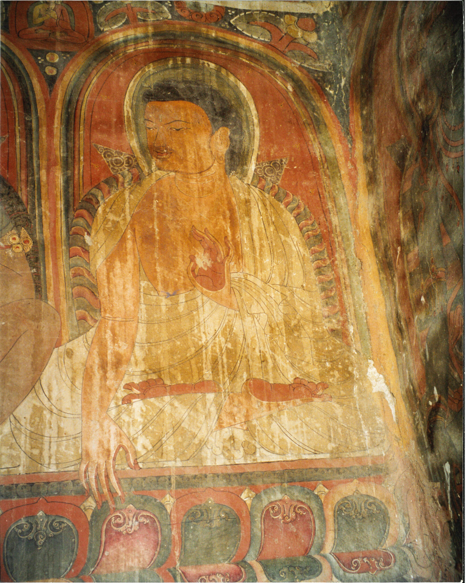 Water-damaged mural depicting Yogi wearing white robe, seated with hands posed in mudras