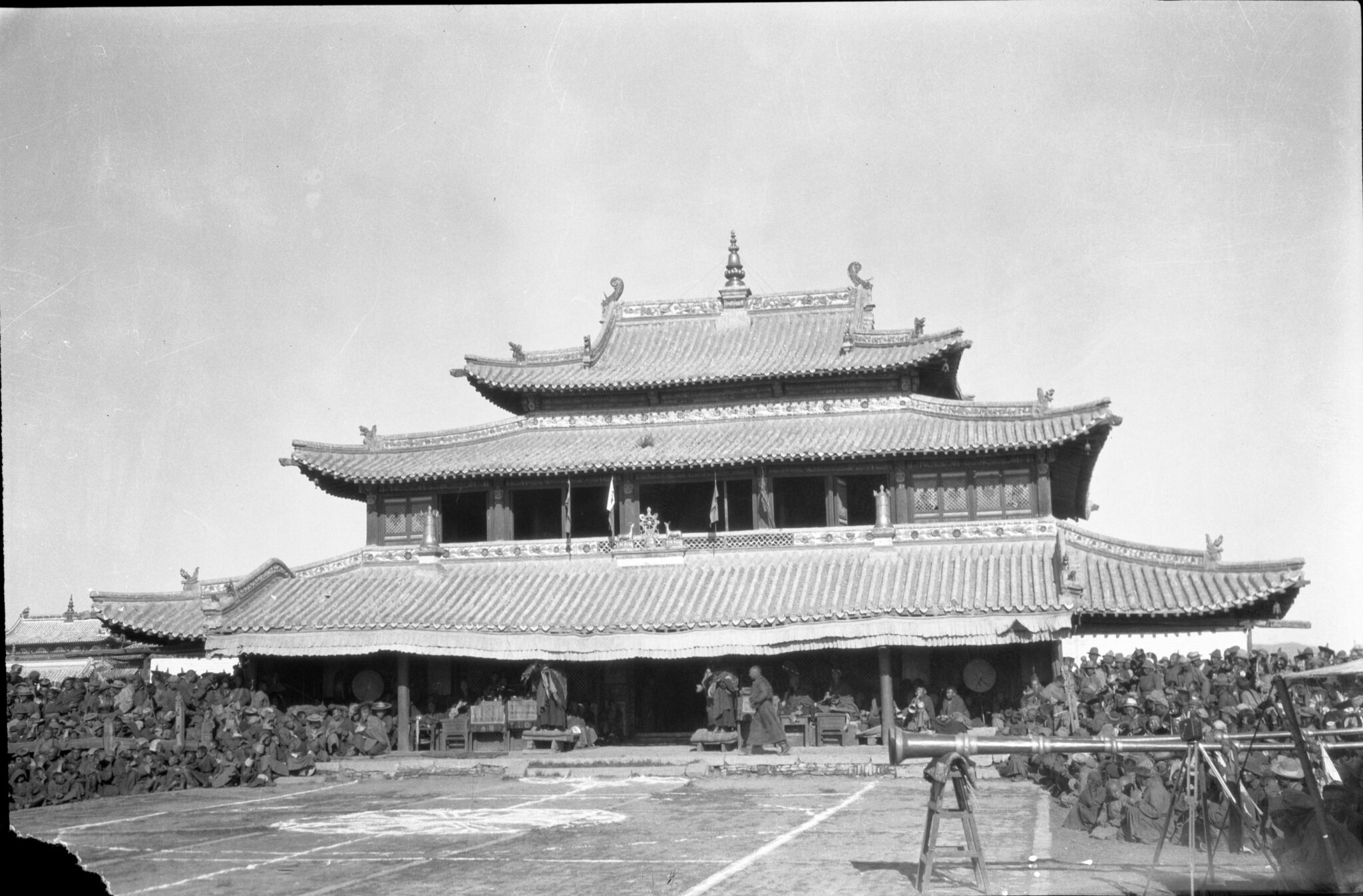 Black and white photograph of forecourt and temple featuring triple-pagoda roof decorated with finials