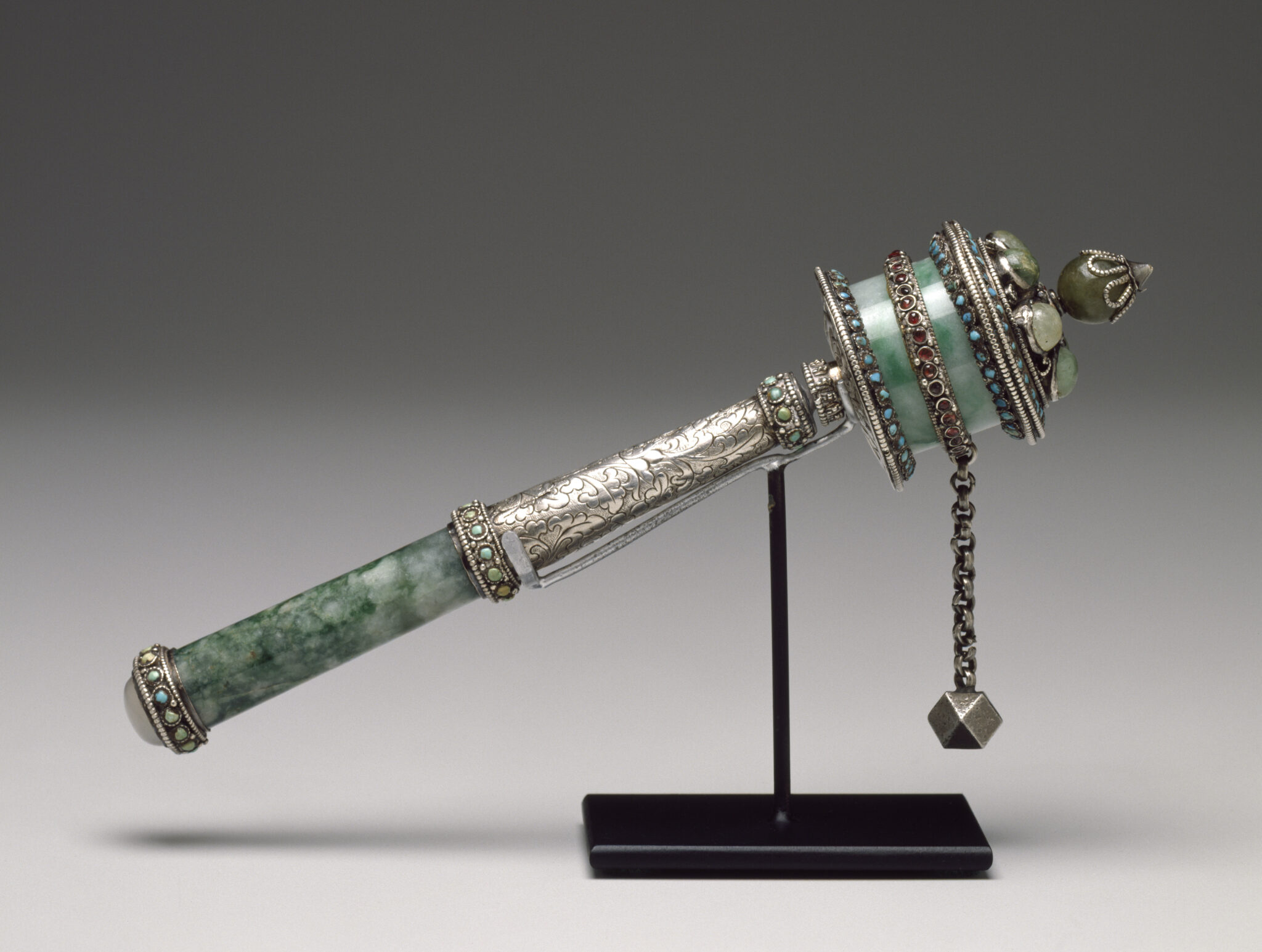 Silver religious implement with blue-green jade accents: ball and chain attached to rotating cylinder mounted on handle