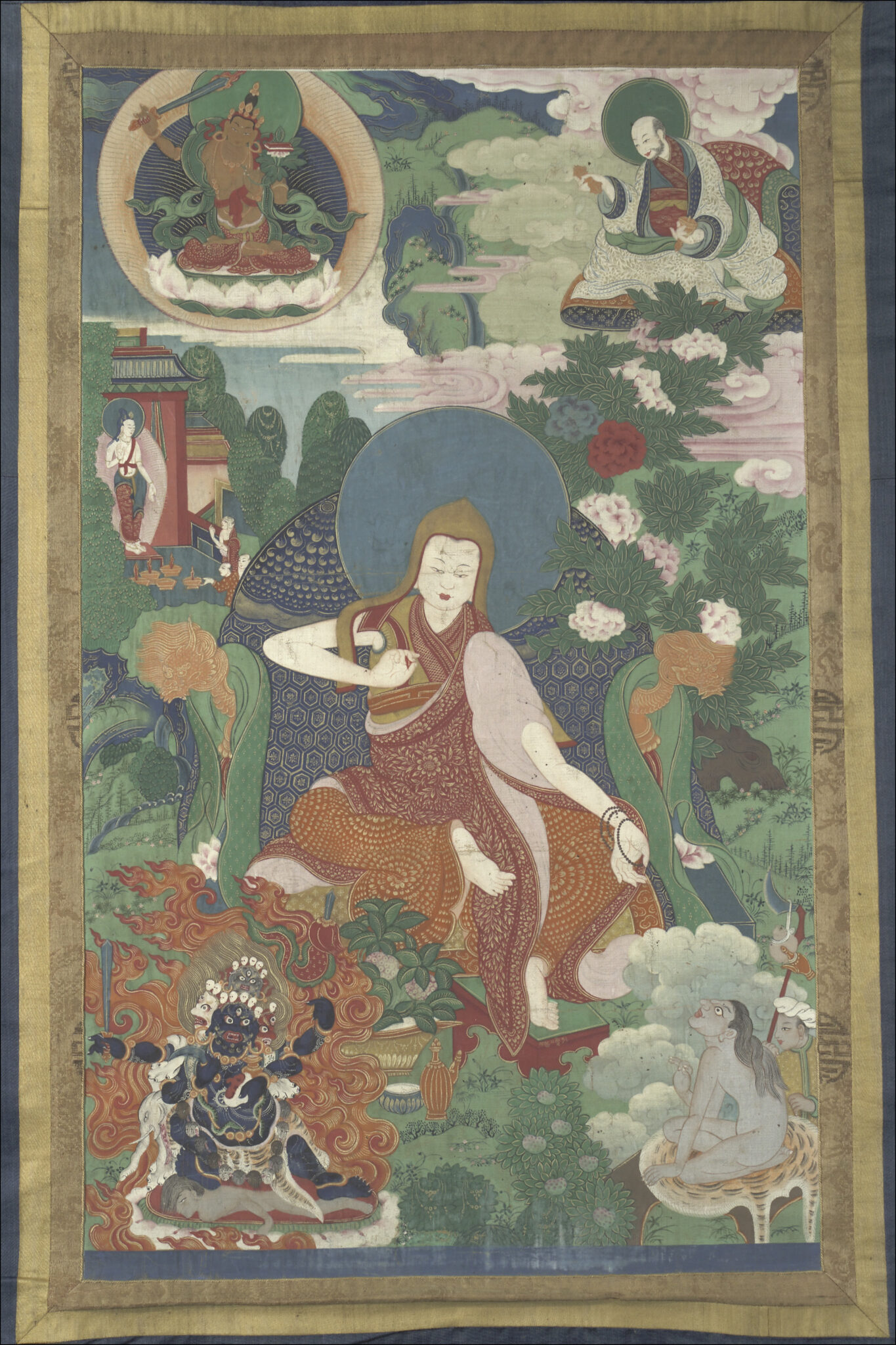 Monk seated on blue throne extends right hand to grey-skinned figure at bottom right