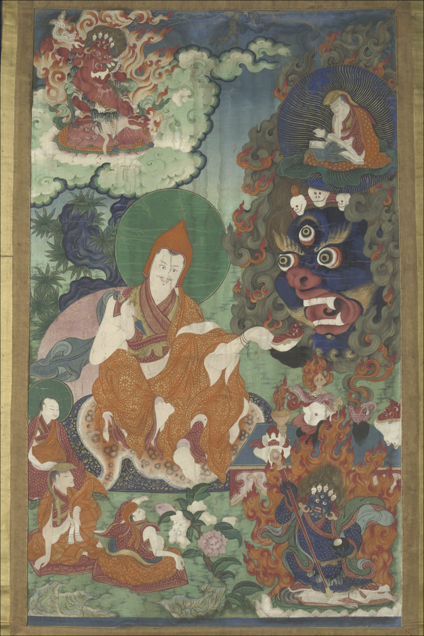 Disciple in tremulous saffron robe inclines head and extends right hand towards monstrous deity at right