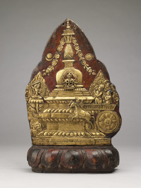 Golden relief on copper plaque depicting stupa and deity behind horse-drawn chariot carrying two figures