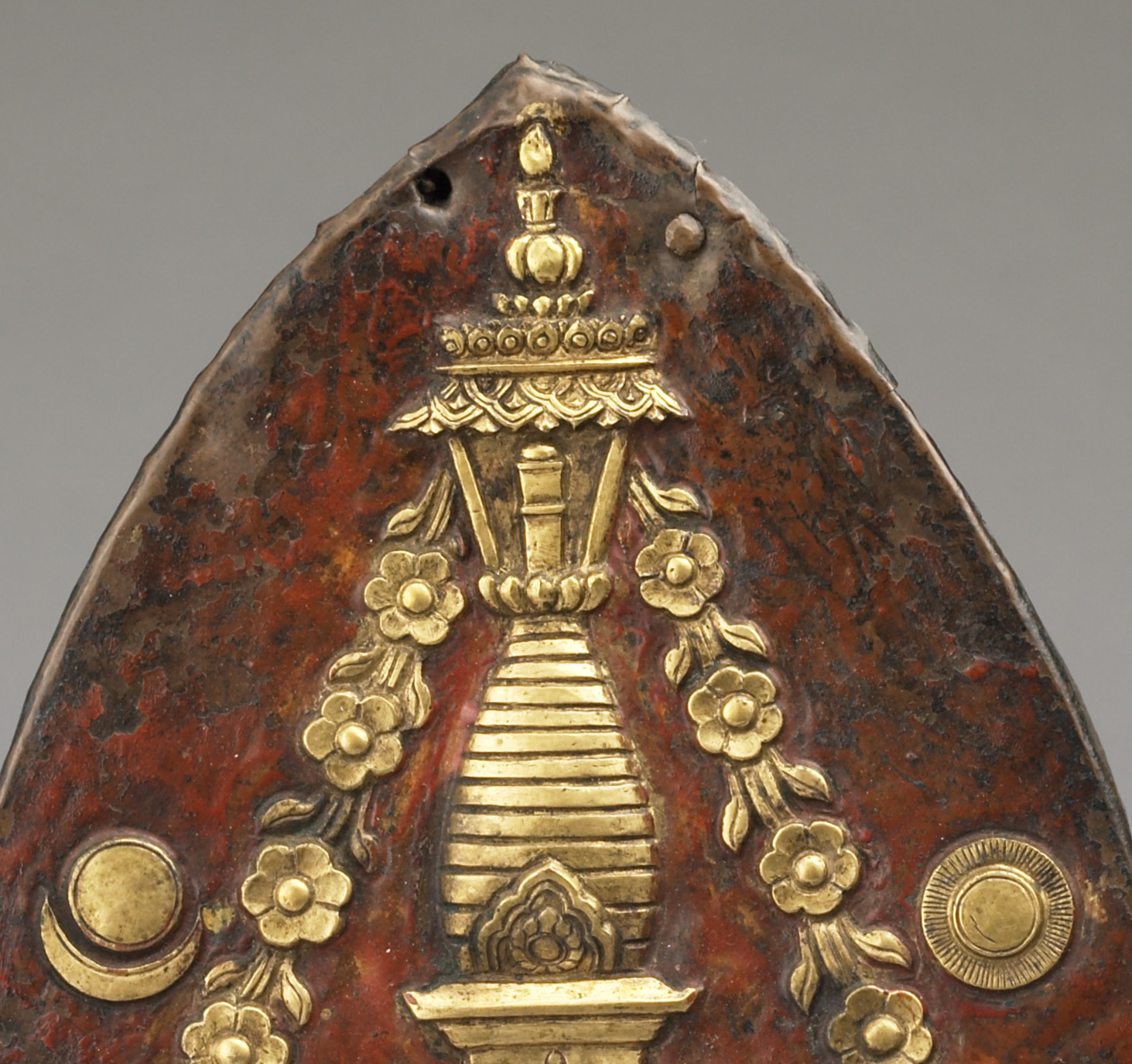 Plaque finial depicting stupa with flower garlands descending from canopy and moon and sun motifs