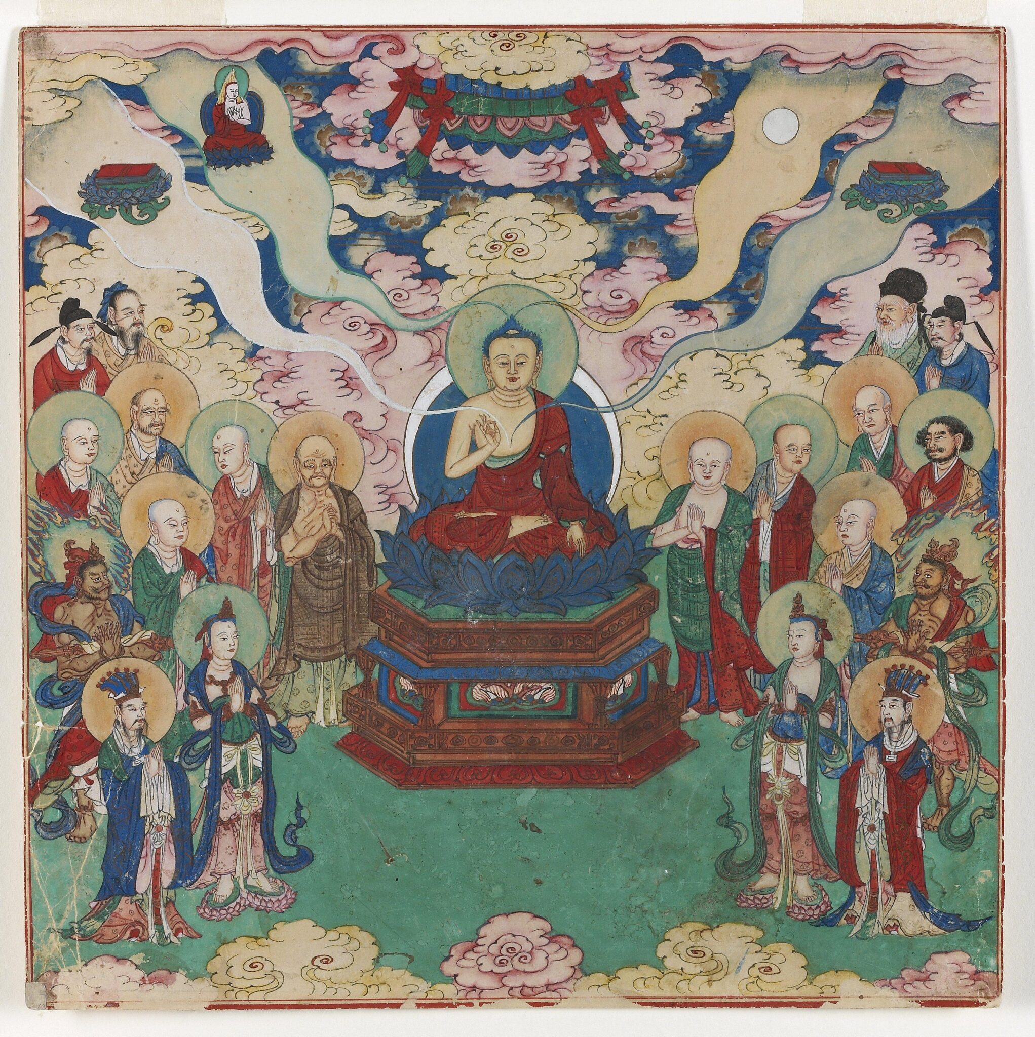 Buddha seated on lotus pedestal flanked by attendants; implements emanate from His head on vaporous trails