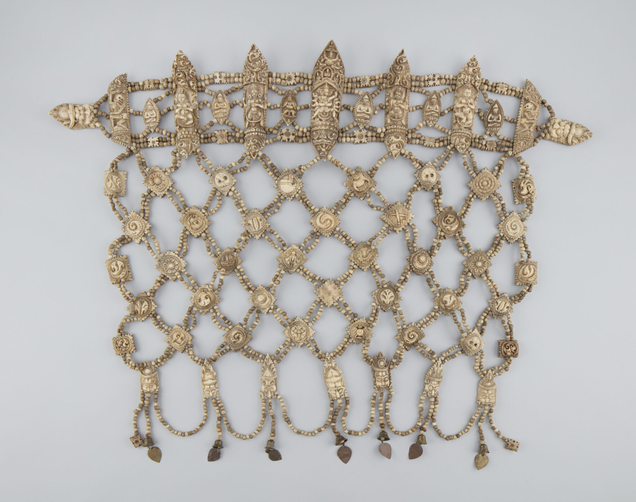 Beaded ritual garment in lattice pattern featuring belt with pointed oblong forms decorated with portraits