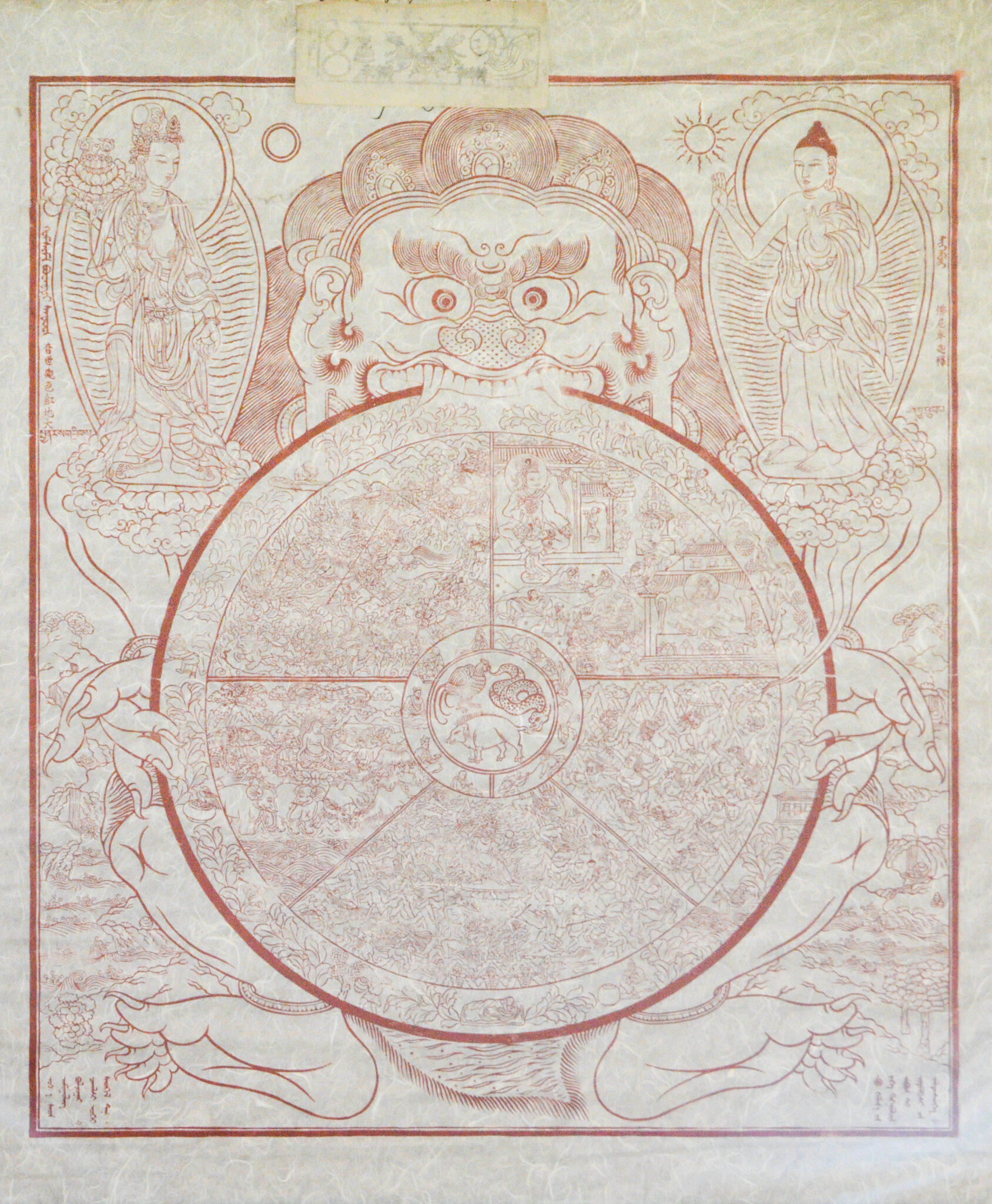 Line drawing in red depicting wheel divided into multiple scenes held in teeth by wrathful deity
