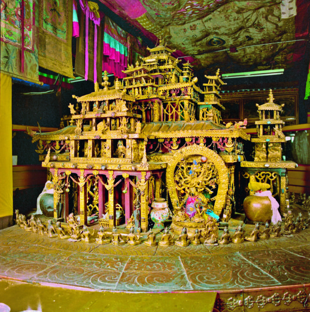 Three-dimensional mandala in form of golden building featuring loggias, towers, and pagoda roofs