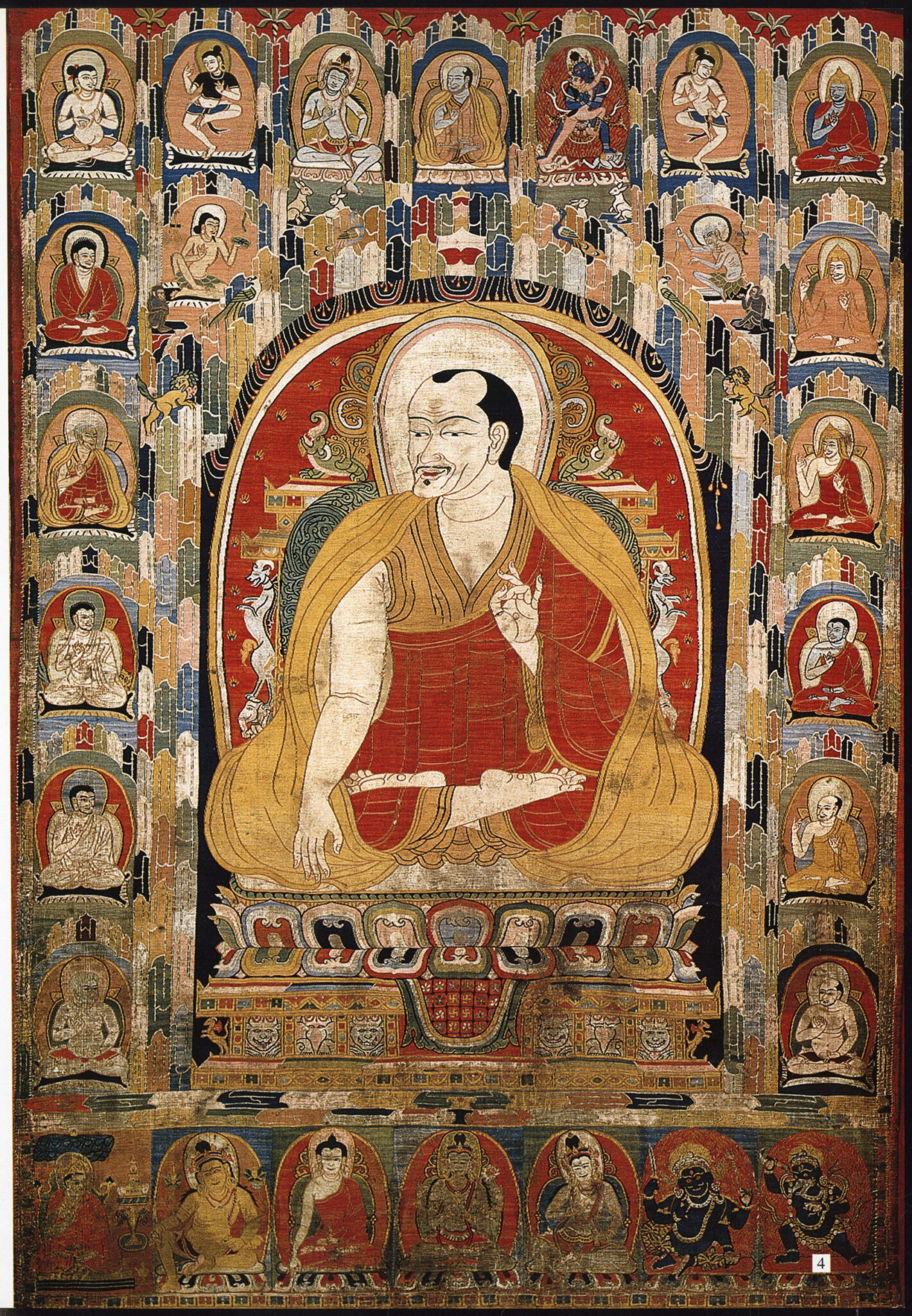 Monk wearing saffron and red robes, hands posed in mudras, seated on lotus pedestal surrounded by miniature portraits