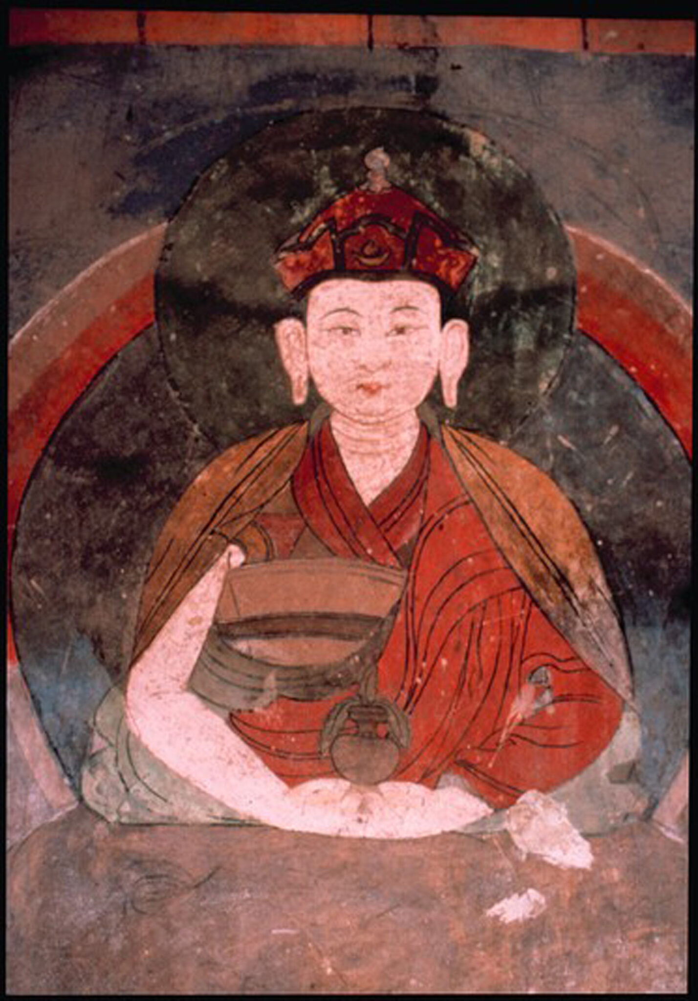 Detail of mural depicting figure wearing red cap and saffron robe; holds urn in folded hands