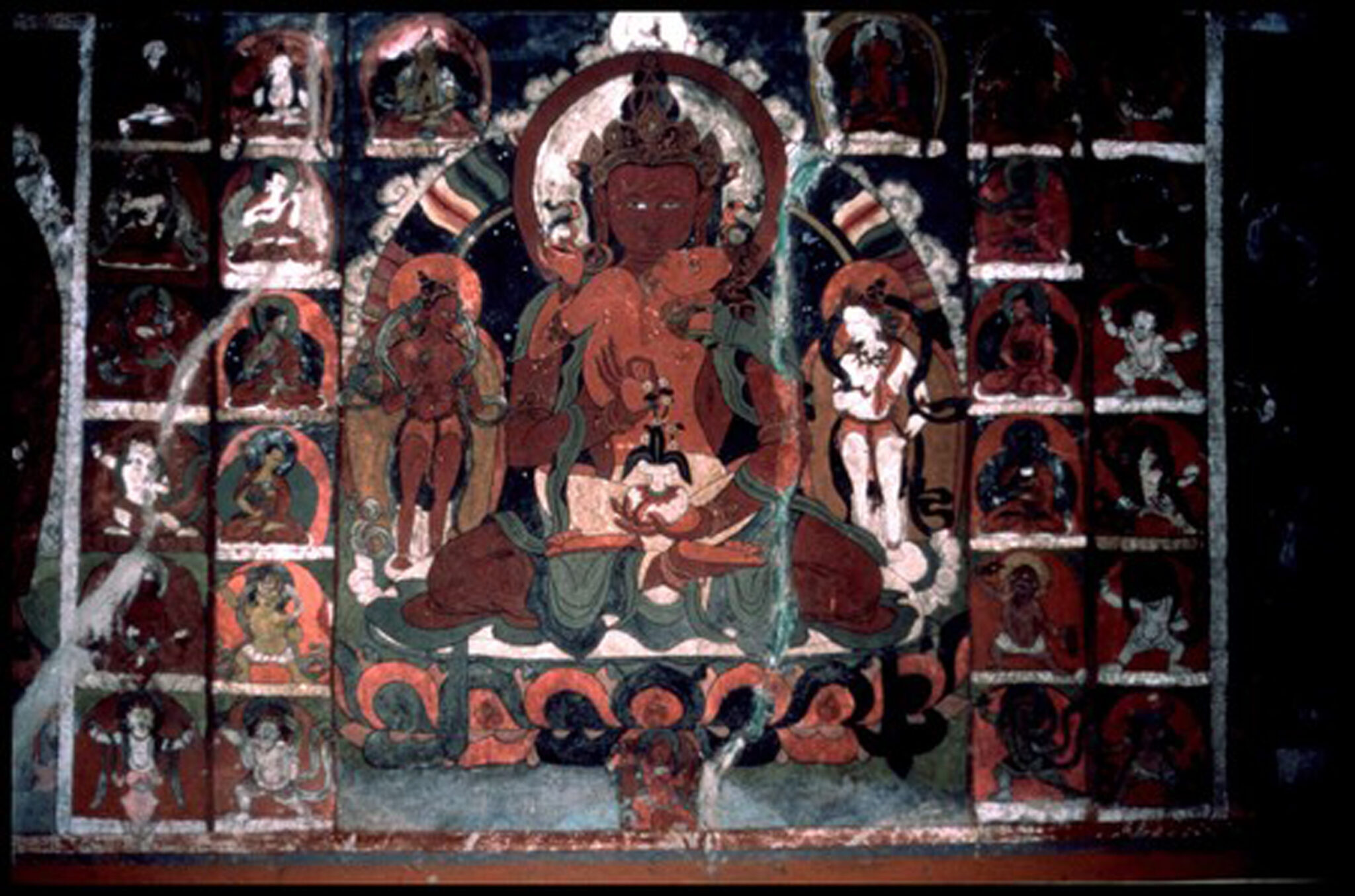 Mural in blood- and rust-red depicting Bodhisattva and consort locked in embrace, flanked by attendants