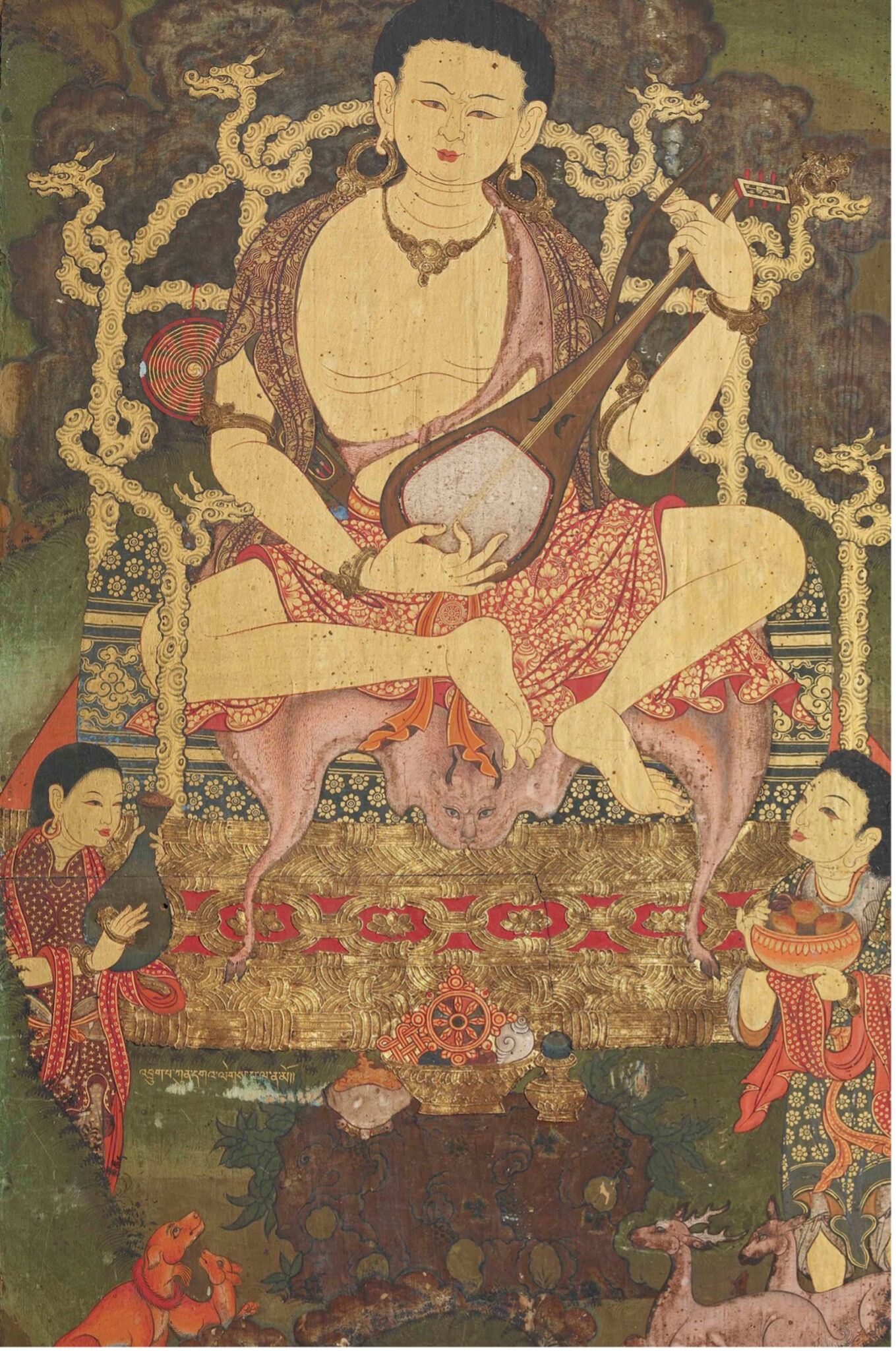 Monk plays stringed instrument while seated on throne featuring back- and armrests in the form of dragons