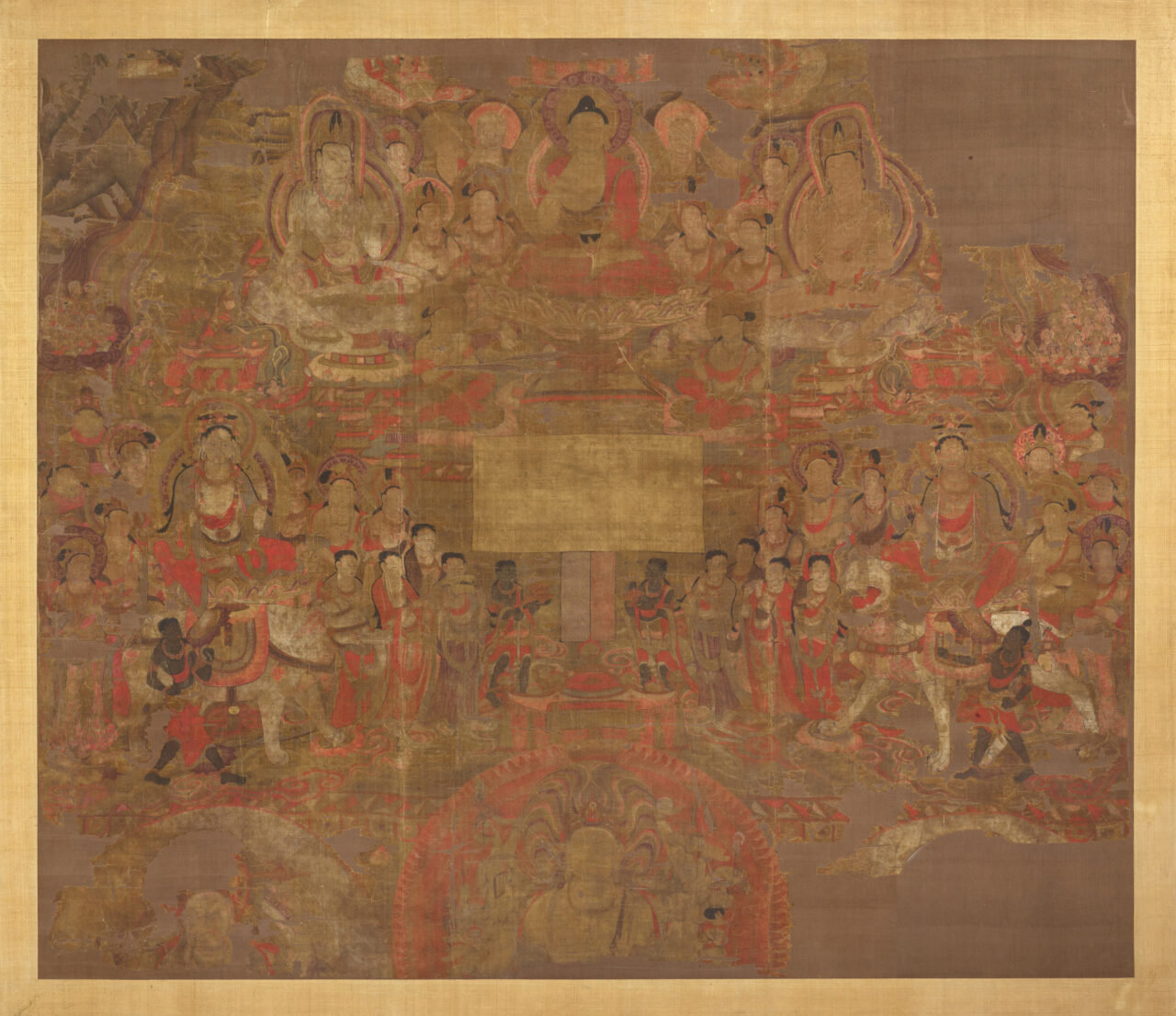 Buddha, two bodhisattvas, and attendants hover above terraced landscape and crowds of people; painted in oranges, reds, and yellows