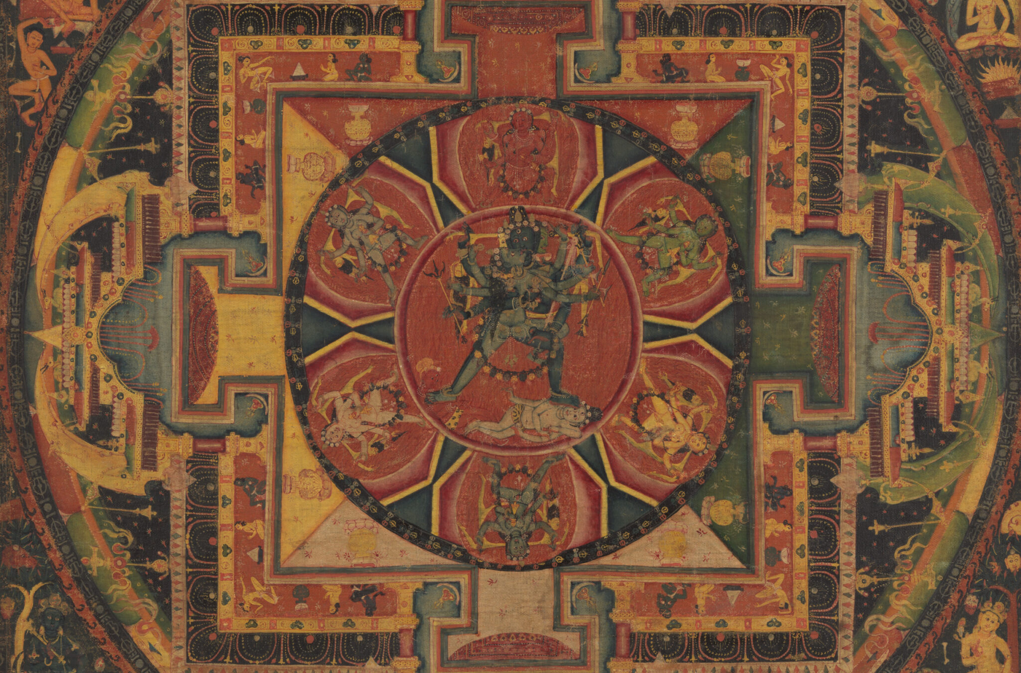 Blue-skinned deity stands in center of geometric arrangement of circles and squares featuring architectural forms at cardinal points