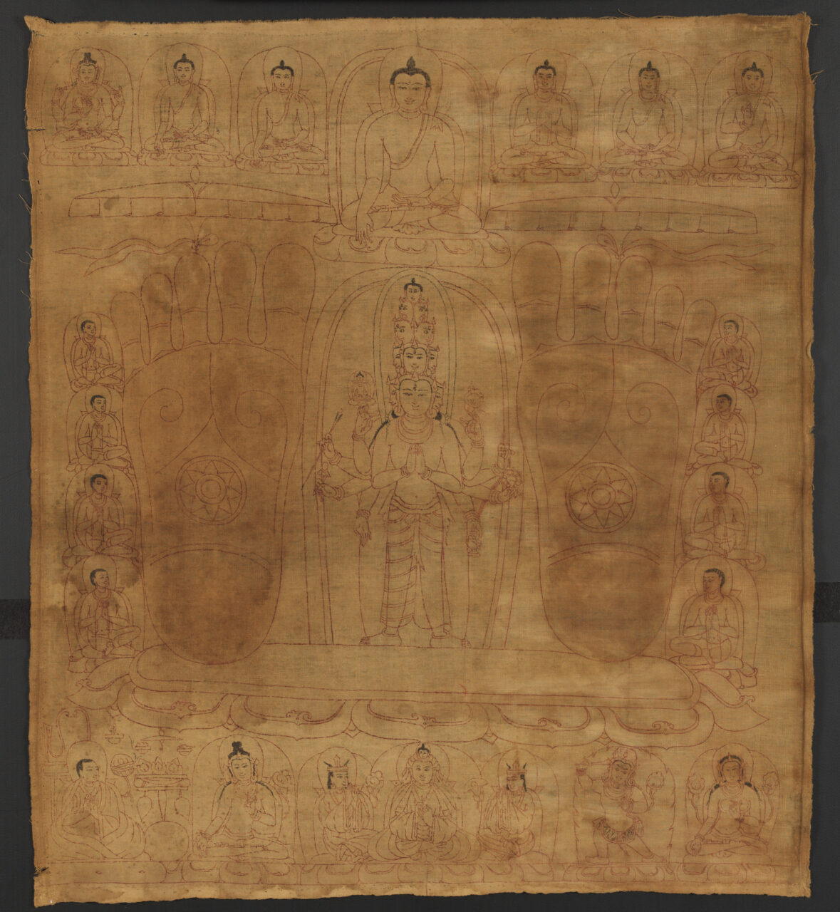 Two faint footprints astride line-drawn many-headed deity, surrounded by deity portraits against sepia background