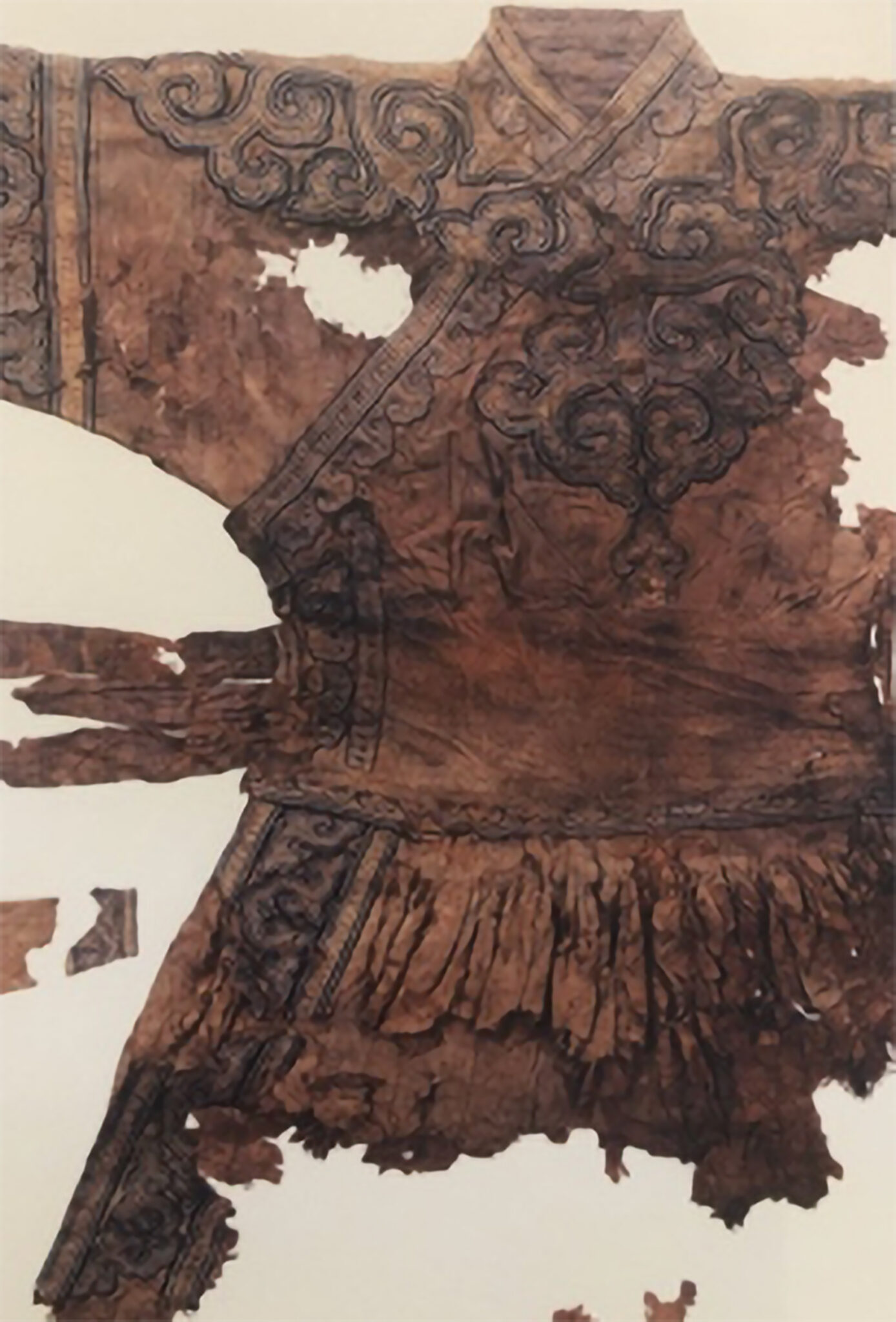 Fragmentary dark-brown tunic featuring swirling cloud motifs at chest and on seams of garment