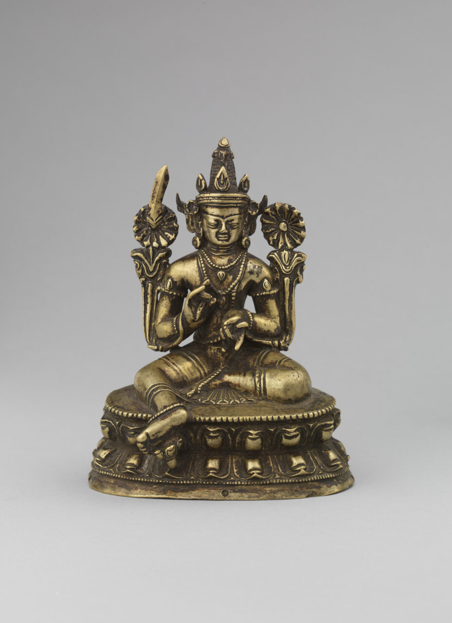 Bronze-colored statue depicting Bodhisattva holding long-stemmed blossoms; seated with left leg extended to ground