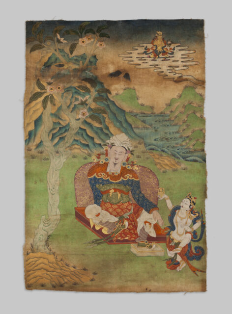 Siddha wearing magnificent blue, gold, and red garments seated in pastoral setting, accompanied by consort or deity