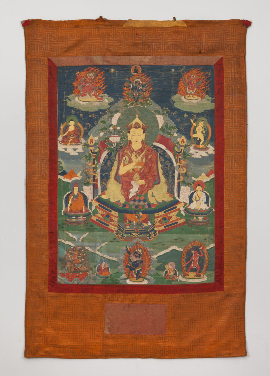 Painting mounted on orange brocade depicting lama seated amidst deity and lama portraits