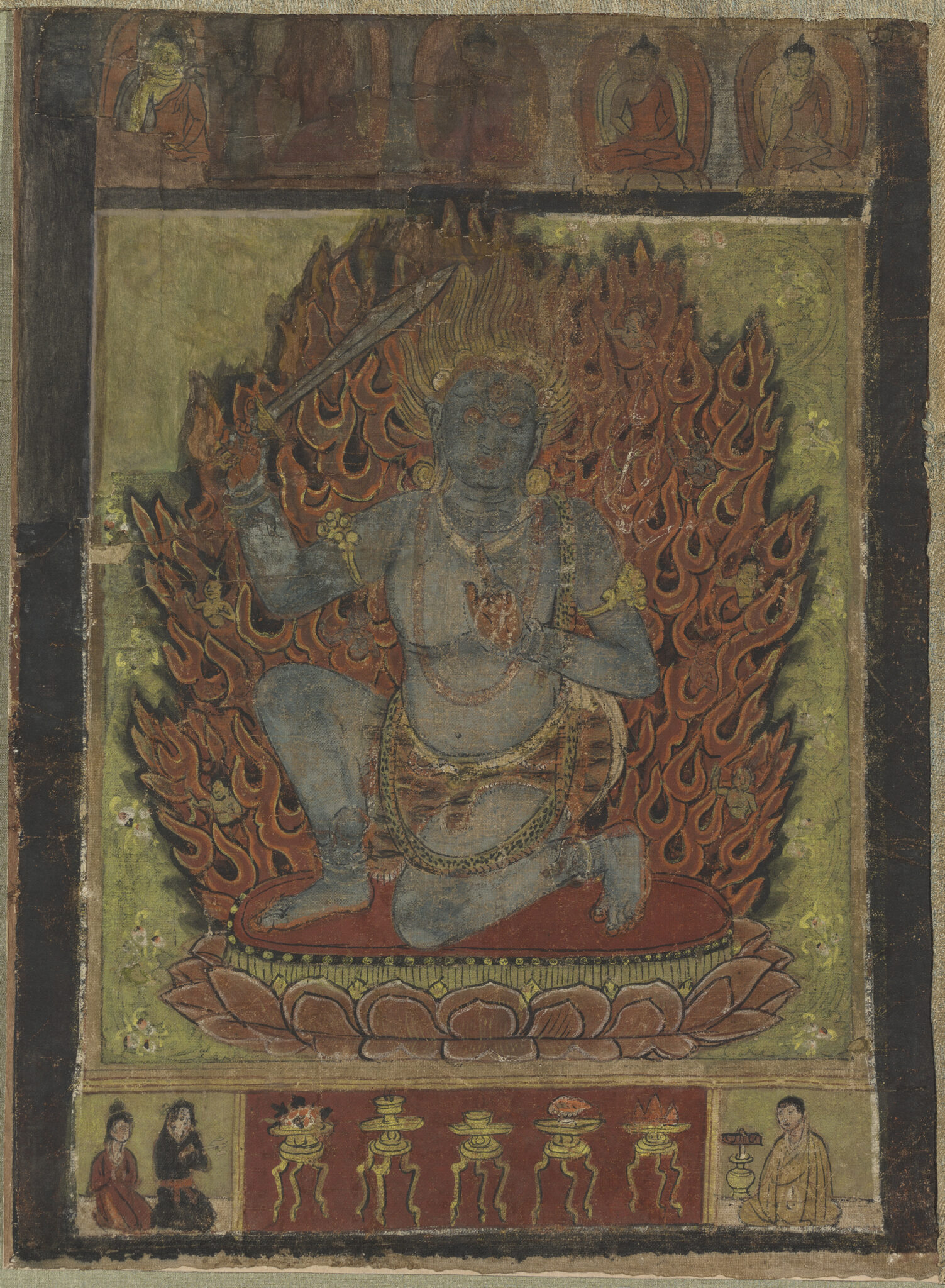 Blue-skinned deity kneeling in dynamic pose before firey nimbus; register at bottom features ritual implements and supplicants