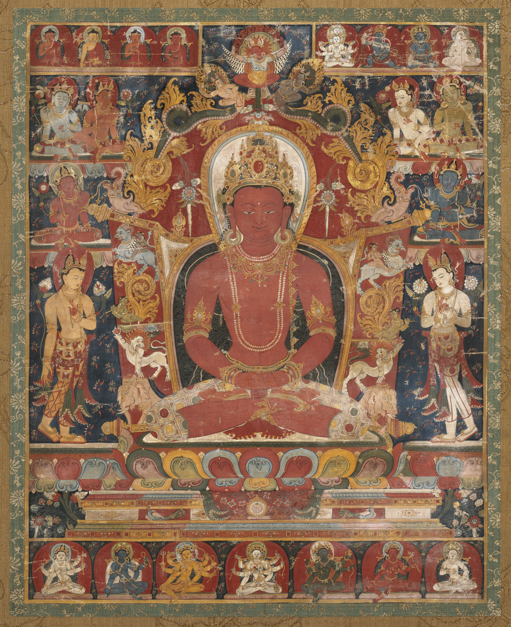 Crowned Buddha seated on lotus throne, surrounded by attendants and deities arranged in registers