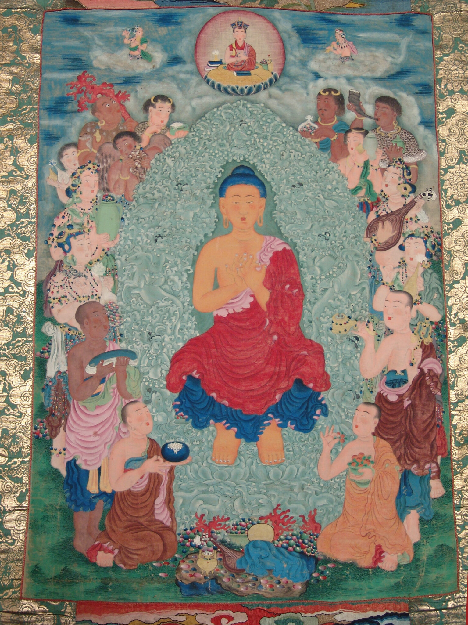 Painting mounted on green and gold damask depicting Buddha surrounded by full-body nimbus and crowd of attendants